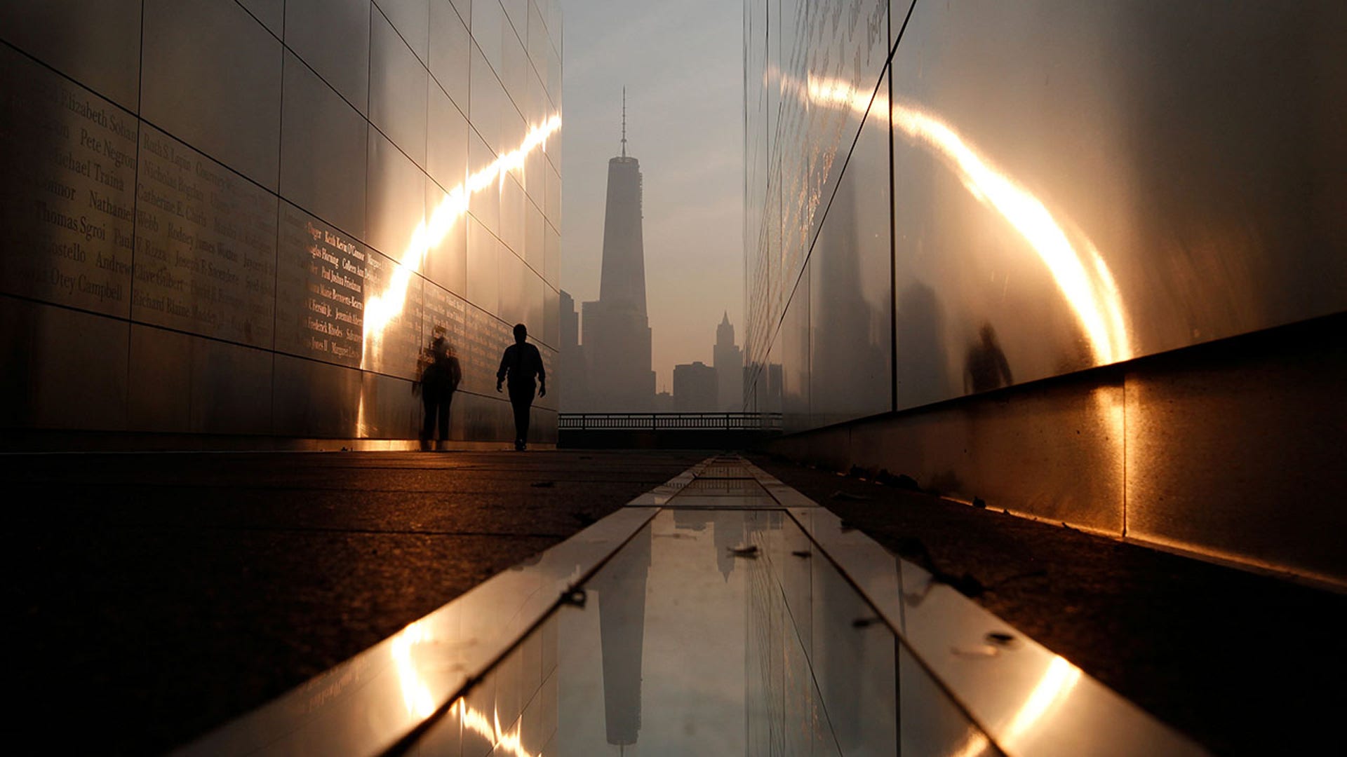 A man walks through the 9/11 Empty Sky memorial at sunrise across from New York's Lower Manhattan and One World Trade Center in Liberty State Park in Jersey City, N.J., on Sept. 11, 2013. (REUTERS/Gary Hershorn/File Photo)