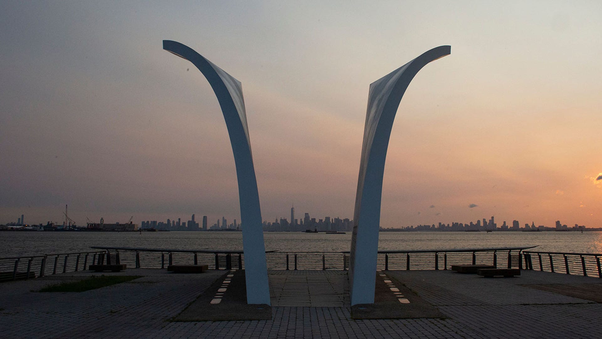 The sun rises behind the Postcards 9/11 memorial by New York architect Masayuki Sono on Staten Island New York on July 30, 2021. Built in 2004, it is a permanent memorial honoring the 274 Staten Island residents killed in the September 11 attacks of 2001 and in the 1993 World Trade Center bombing. Twenty years later, tucked between the buildings and boroughs of New York City, memorials and reminders can be found of a day that left nearly 3,000 people dead  ensuring the city that never sleeps will also never forget. (Photo by KENA BETANCUR/AFP via Getty Images)
