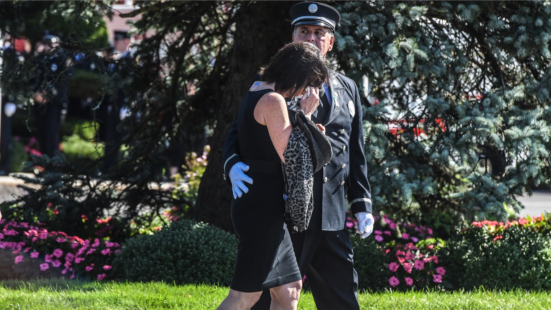HOLBROOK, NY - SEPTEMBER 26: A person cries outside of a funeral home after paying respects to Gabby Petito on September 26, 2021 in Holbrook, New York. As the search continues into a second week in Florida to find Brian Laundrie, who is a person of interest, the family of Gabby Petito is holding a public funeral in her hometown of Long Island. 