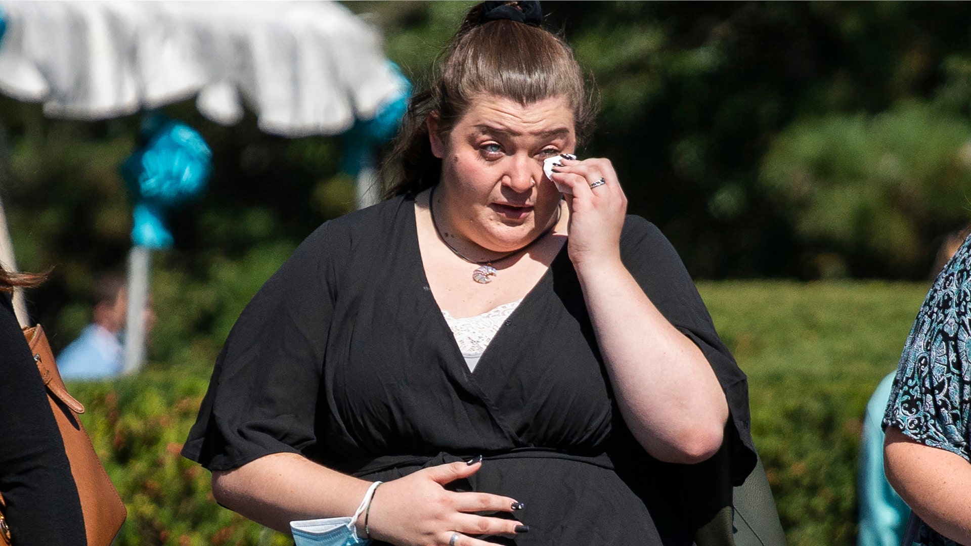  A woman wipes her tears after attending the funeral home viewing of Gabby Petito at Moloney's Funeral Home in Holbrook, N.Y. Sunday, Sept. 26, 2021. (AP Photo/Eduardo Munoz Alvarez)