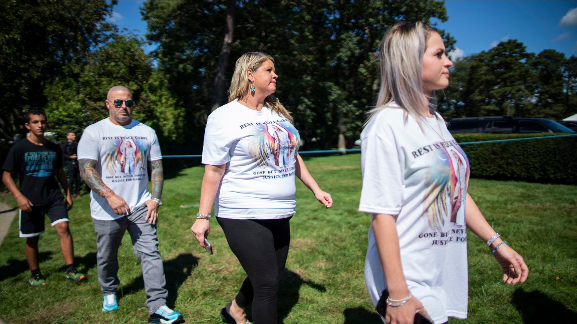  People wear T-shirts with images of Petito as they attend the funeral home viewing of Gabby Petito at Moloney's Funeral Home in Holbrook, N.Y. Sunday, Sept. 26, 2021. 