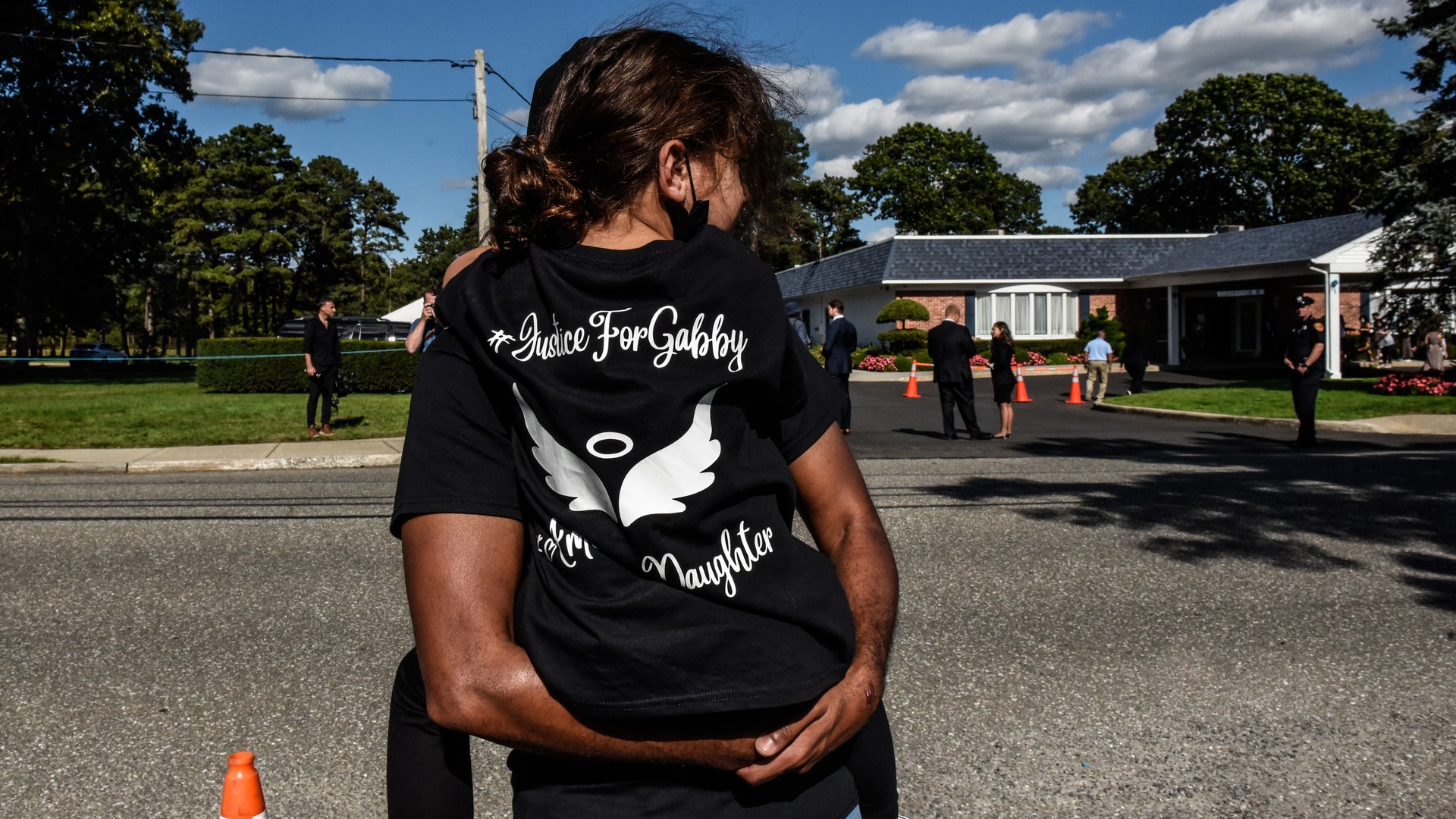 HOLBROOK, NY - SEPTEMBER 26: Mourners gather at a funeral home to pay respects to Gabby Petito on September 26, 2021 in Holbrook, New York. As the search continues for a second week in Florida to find Brian Laundrie, who is a person of interest, the family of Gabby Petito is holding a public funeral in her hometown of Long Island. 
