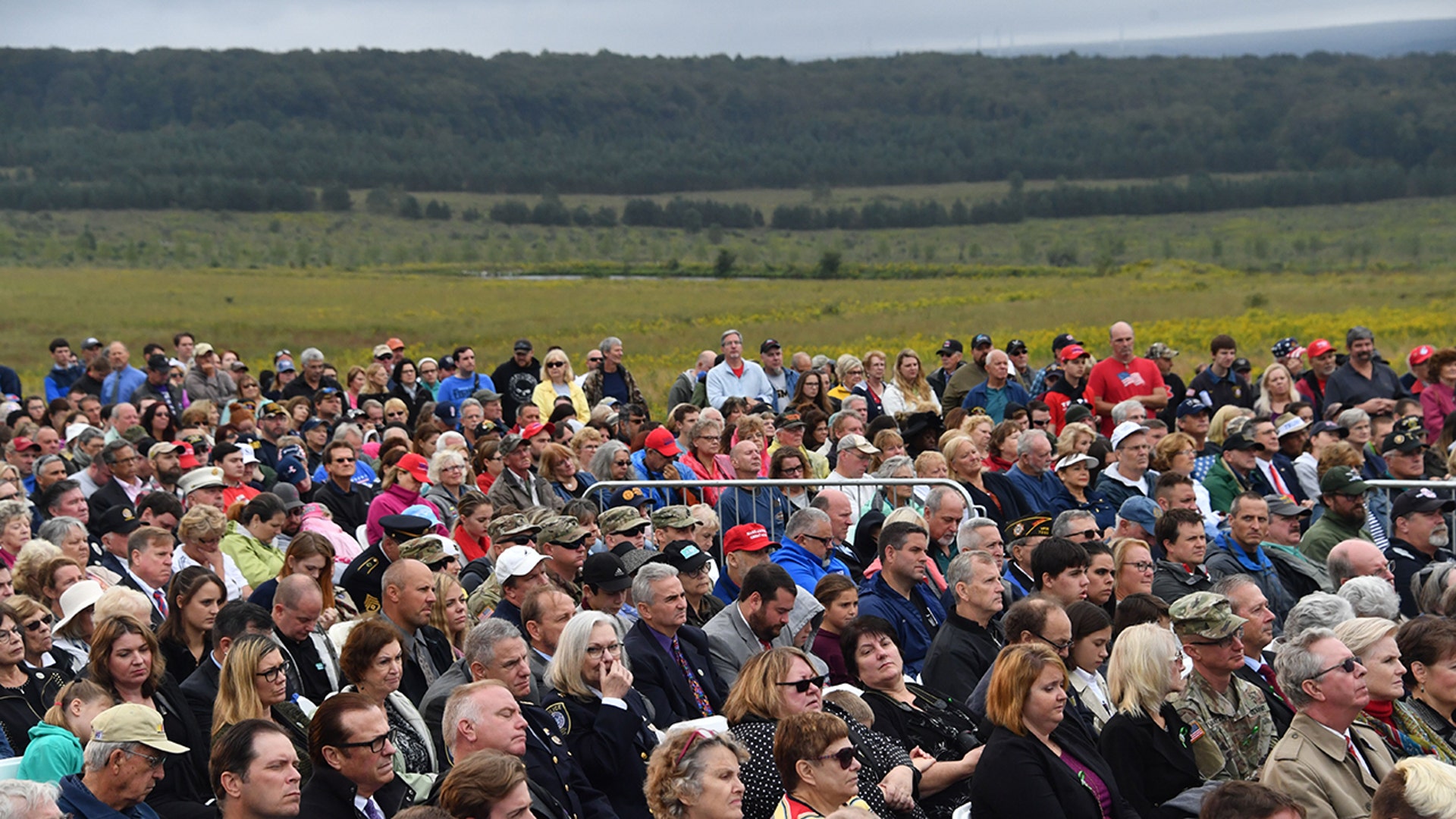 People gather as President Trump speaks on Sept. 11, 2018, at the site of a new memorial in Shanksville, Pa., where Flight 93 crashed during the September 11 attacks, as somber ceremonies take place at Ground Zero in New York and at the Pentagon. (NICHOLAS KAMM/AFP via Getty Images)