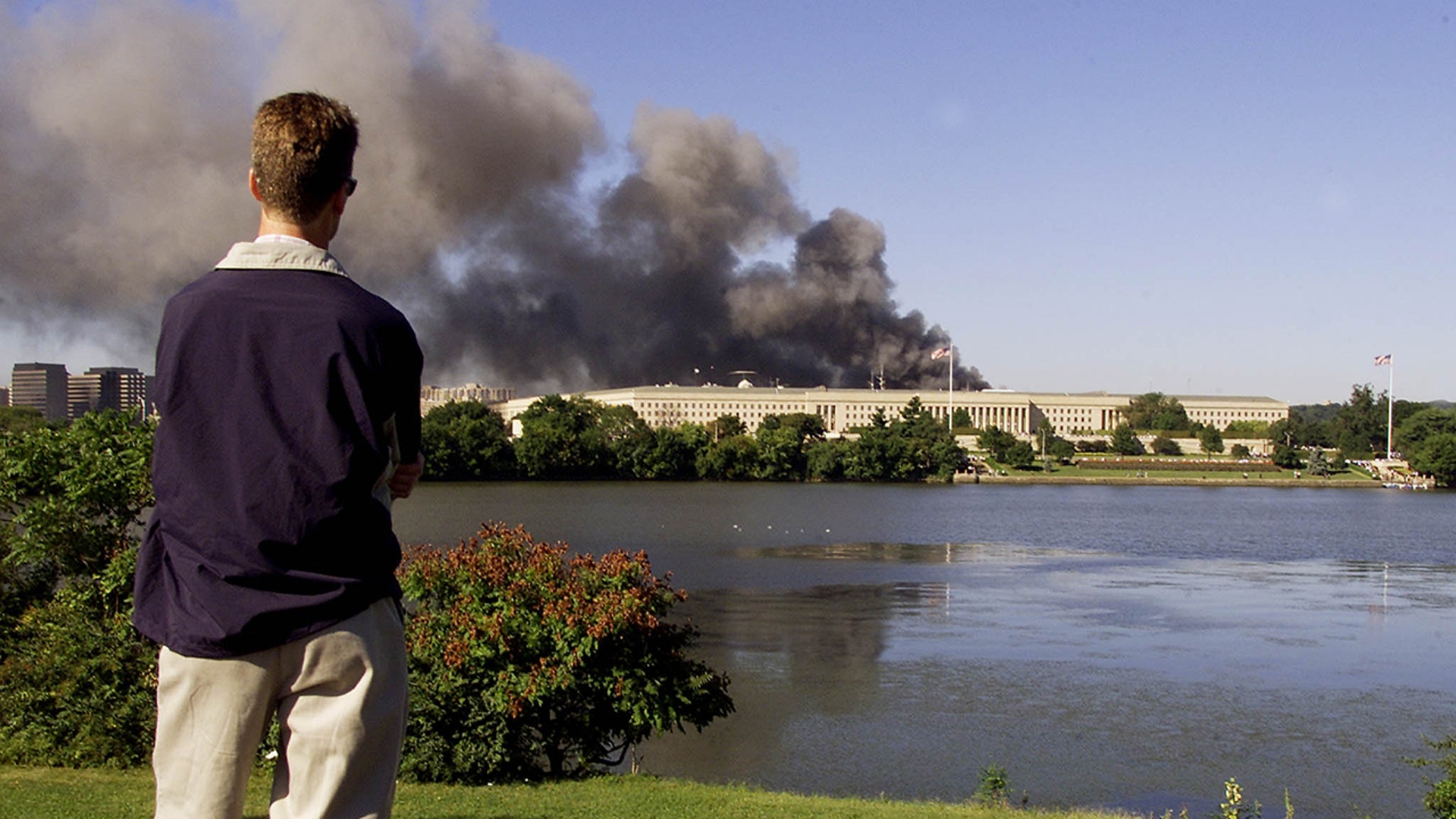 An unidentified motorist watches smoke billow from the Pentagon in Washington, D.C., Sept. 11, 2001, after an airplane crashed into it. (LUKE FRAZZA/AFP via Getty Images)