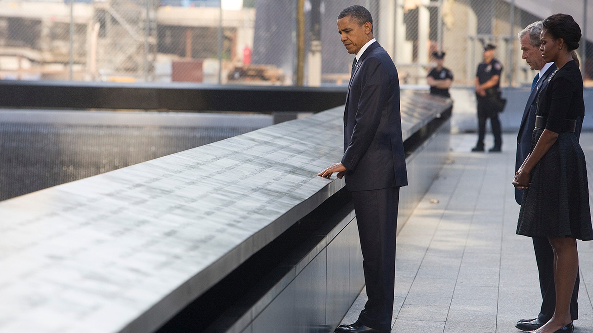 President Obama, first lady Michelle Obama, former President George W. Bush and former first lady Laura Bush look out at the North Pool of the 9/11 Memorial during the 10th-year ceremonies of the Sept. 11, 2001, terrorist attacks at the World Trade Center site, Sept. 11, 2011, in New York City. (Photo by Kristoffer Tripplaar-Pool/Getty Images)