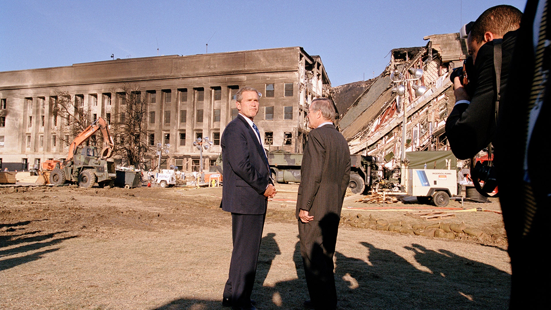 President George W. Bush and Secretary of Defense Donald Rumsfeld survey the damage at the Pentagon building Sept. 12, 2001, in Arlington, Va, a day after the Sept. 11, 2001, terrorist attacks in Washington, D.C., and New York. (Photo by David Hume Kennerly/Getty Images)