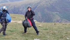 Tom Cruise surprises hikers after landing helicopter, parachuting off cliff