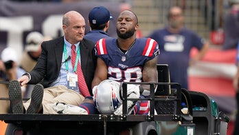 Patriots star James White carted off the field with hip injury