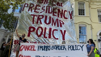 Protesters outside Mayorkas' house unfold giant foil blanket tying Biden to Trump