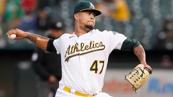 Montas reaches 200 Ks, A's pound first-place Astros 14-2