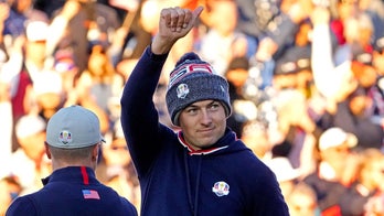 Jordan Spieth somehow gets this shot onto the green and nearly falls into Lake Michigan