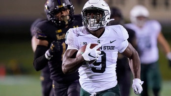 Walker runs for 264 yards as Spartans beat Wildcats 38-21