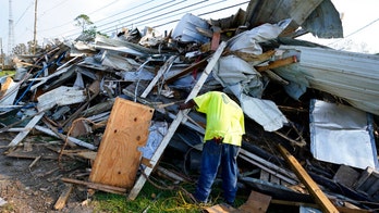 Ida-battered New Orleans cleans up trash as streets begin to stink