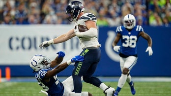 Seahawks’ Will Dissly with an abusive stiff arm