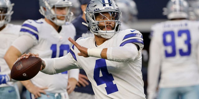 Dallas Cowboys quarterback Dak Prescott (4) warms up before an NFL football game against the Philadelphia Eagles in Arlington, Texas, Monday, Sept. 27, 2021.