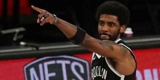 Brooklyn Nets point guard Kyrie Irving (11) reacts after a three-point shot against the Milwaukee Bucks in the third quarter of Game 1 of the Eastern Conference Semifinals of the 2021 NBA Playoffs at Barclays Center.