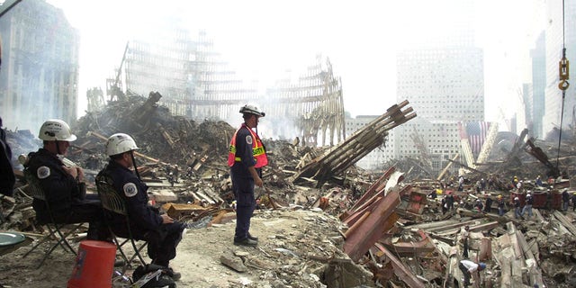 Rescue workers sift through debris at Ground Zero of what remains of the World Trade Center twin towers site Sept. 24, 2001.