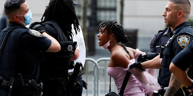 Police detain demonstrators attending a Black Lives Matter (BLM) protest at the Met Gala 2021 at the Metropolitan Museum of Art in New York City, New York, U.S. September 13, 2021.