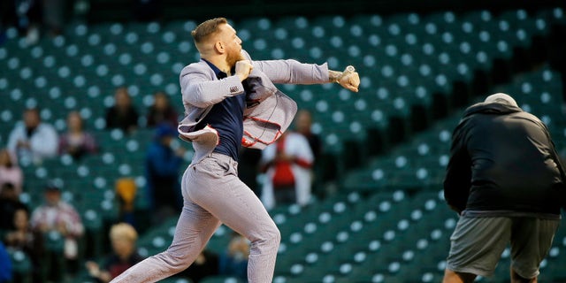 Sep 21, 2021; Chicago, Illinois, USA; MMA fighter Conor McGregor throws out a ceremonial first pitch before the game between the Chicago Cubs and the Minnesota Twins at Wrigley Field. Mandatory Credit: Jon Durr-USA TODAY Sports