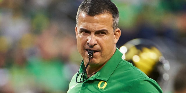 Oregon Ducks head coach Mario Cristobal keeps a watchful eye on players during warmups before a game against the Arizona Wildcats at Autzen Stadium. 