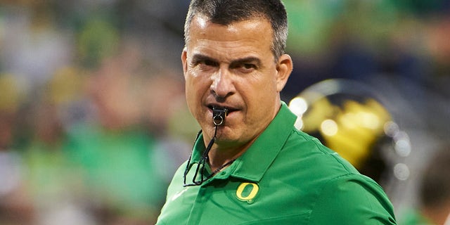 Oregon Ducks head coach Mario Cristobal keeps a watchful eye on players during warmups before a game against the Arizona Wildcats at Autzen Stadium.