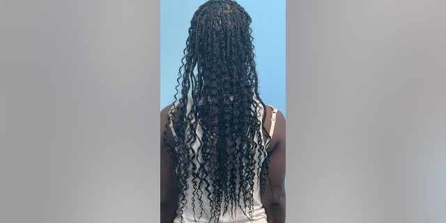 Brittany Starks braiding children's hair in Nashville, Tennessee.