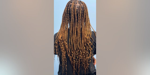 Brittany Starks braiding children's hair in Nashville, Tennessee.
