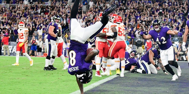 Baltimore Ravens quarterback Lamar Jackson (8) flips into the end zone for  a fourth quarter touchdown  against the Kansas City Chiefs at M&amp;T Bank Stadium. 