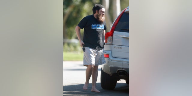 Former child star Angus T. Jones is unrecognizable from his 'Two and a Half Men' days as he walks barefoot around Los Angeles and has a thick bushy beard.