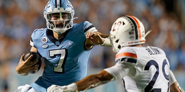 North Carolina quarterback Sam Howell (7) runs the ball as Virginia free safety Joey Blount (29) defends during the second half of an NCAA college football game in Chapel Hill, N.C., Saturday, Sept. 18, 2021.