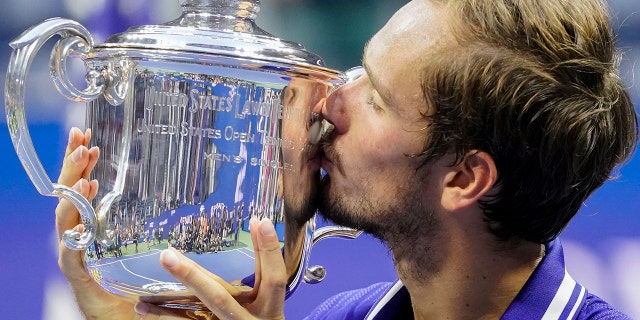 Daniil Medvedev, of Russia, kisses the championship trophy after defeating Novak Djokovic, of Serbia, in the men's singles final of the US Open tennis championships, Sunday, Sept. 12, 2021, in New York. (AP Photo/John Minchillo)