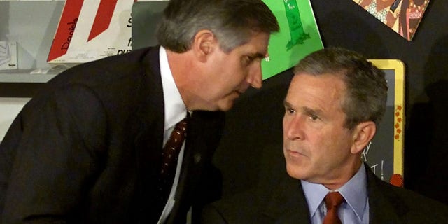 U.S. President George W. Bush listens as White House Chief of Staff Andrew Card informs him of a second plane hitting the World Trade Center while Bush was conducting a reading seminar at the Emma E. Booker Elementary School in Sarasota, Florida, September 11, 2001. REUTERS/Win McNamee-Files HB/