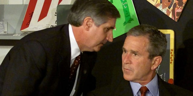 U.S. President George W. Bush listens as White House Chief of Staff Andrew Card informs him of a second plane hitting the World Trade Center while Bush was conducting a reading seminar at the Emma E. Booker Elementary School in Sarasota, Florida, September 11, 2001. REUTERS/Win McNamee-Files HB/