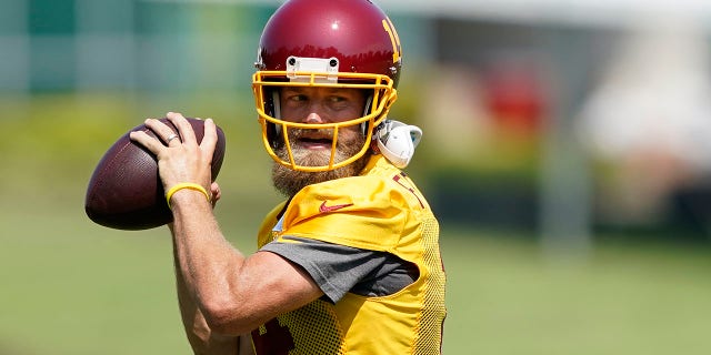 Washington Football Team quarterback Ryan Fitzpatrick throws during practice at the team's training facility in Ashburn, Va., Aug. 25, 2021.