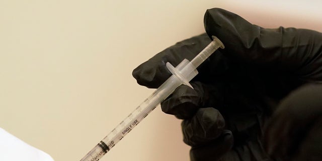 A woman is injected with her second dose of the Pfizer COVID-19 vaccine at a Dallas County Health and Human Services vaccination site in Dallas, Thursday, Aug. 26, 2021. 