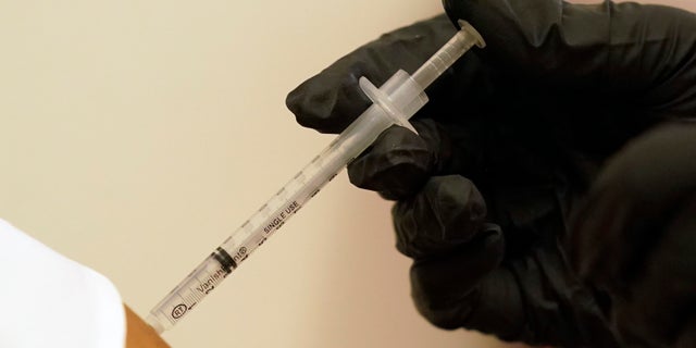 A woman is injected with her second dose of the Pfizer COVID-19 vaccine at a Dallas County Health and Human Services vaccination site in Dallas, Thursday, Aug. 26, 2021.