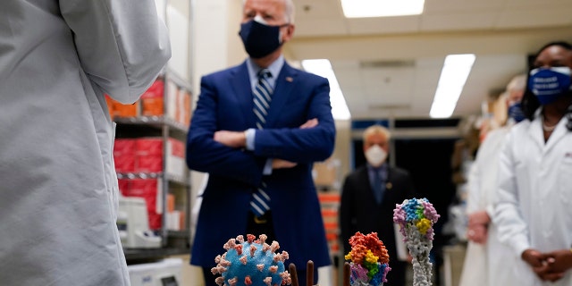 In this Feb. 11, 2021 file photo, President Joe Biden visits the Viral Pathogenesis Laboratory at the National Institutes of Health (NIH) in Bethesda, Md.