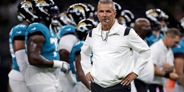 FILE - In this Monday, Aug. 23, 2021, file photo, Jacksonville Jaguars head coach Urban Meyer watches as his team warms up before a preseason NFL = football game against the New Orleans Saints in New Orleans.