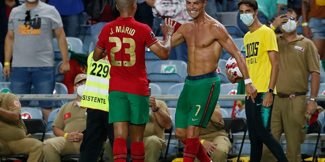 Portugal's Cristiano Ronaldo, right, celebrates after scoring his side's second goal during the World Cup 2022 group A qualifying soccer match between Portugal and the Republic of Ireland at the Algarve stadium outside Faro, Portugal, Wednesday, Sept. 1, 2021. (WHD Photo/Armando Franca)