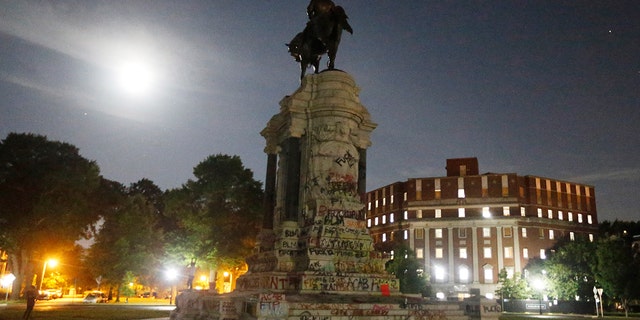 The moon illuminates the statue of Confederate General Robert E. Lee on Monument Avenue Friday June. 5, 2020, in Richmond, Virginia. (Associated Press)