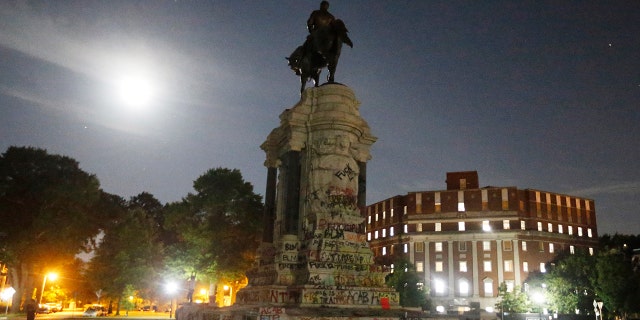 The moon illuminates the statue of Confederate General Robert E. Lee on Monument Avenue Friday June. 5, 2020, in Richmond, Virginia. (Associated Press)