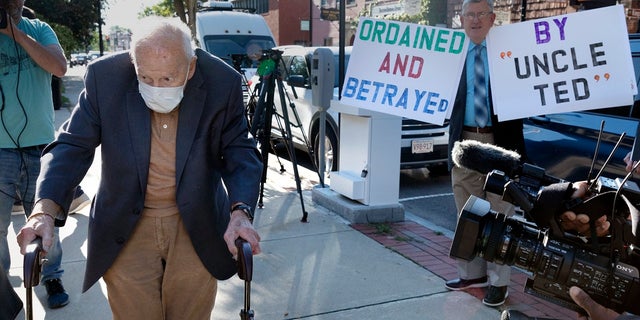 Former Cardinal Theodore McCarrick, left, arrives at Dedham District Court, Friday, Sept. 3, 2021, in Dedham, Mass. (AP Photo/Michael Dwyer)
