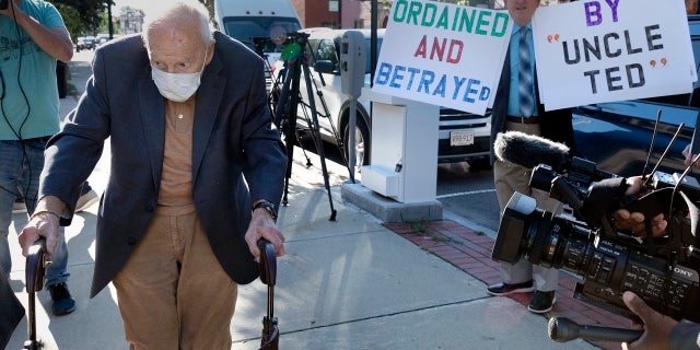 Former Cardinal Theodore McCarrick, left, arrives at Dedham District Court, Friday, Sept. 3, 2021, in Dedham, Mass. (AP Photo/Michael Dwyer)