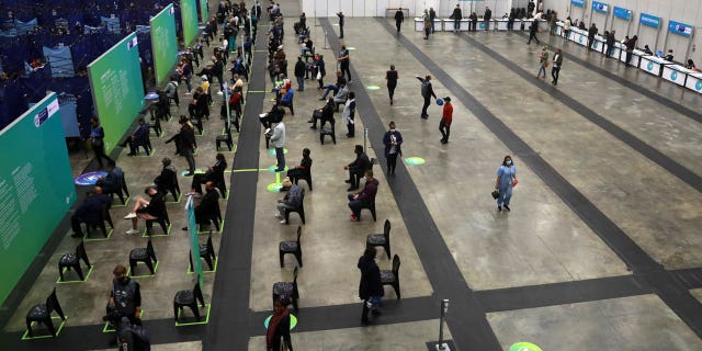People wait to get vaccinated at the Vaccination Centre of Hope at the Cape Town International Convention Centre in Cape Town, South Africa, Tuesday Aug. 24, 2021. South Africa's Health Minister Joe Phaahla says on Friday, Sept. 3, 2021 the government will let businesses decide whether or not to make vaccinations mandatory for employees clients. He said restaurants, bars, grocery stores other businesses must set their own policies on whether or not to insist that patrons must be vaccinated. (AP Photo/Nardus Engelbrecht)