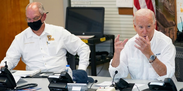 President Joe Biden participates in a briefing about the response to damage caused by Hurricane Ida, at the St. John Parish Emergency Operations Center, Friday, Sept. 3, 2021, in LaPlace, La., as Louisiana Gov. John Bel Edwards listens. (AP Photo/Evan Vucci)