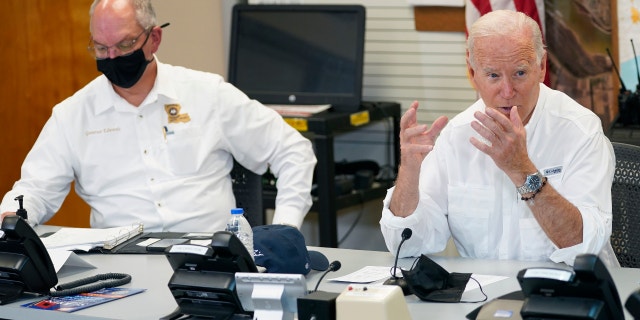 President Joe Biden participates in a briefing about the response to damage caused by Hurricane Ida, at the St. John Parish Emergency Operations Center, Friday, Sept. 3, 2021, in LaPlace, La., as Louisiana Gov. John Bel Edwards listens. (AP Photo/Evan Vucci)