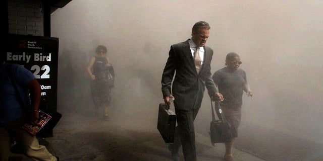 Pedestrians flee the area of New York's World Trade Center in lower Manhattan on Tuesday, Sept. 11, 2001. (AP Photo/Amy Sancetta)