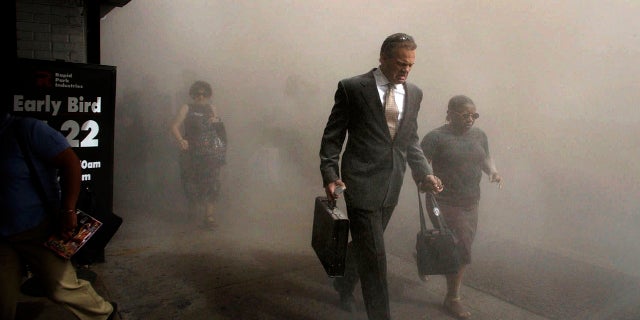 Pedestrians flee the area of New York's World Trade Center in lower Manhattan on Tuesday, Sept. 11, 2001. (AP Photo/Amy Sancetta)