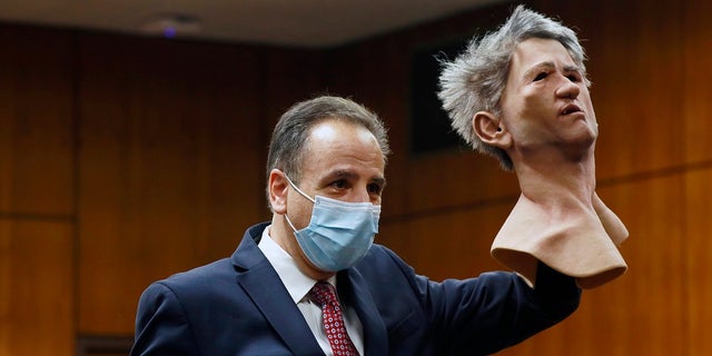 Deputy District Attorney Habib A. Balian holds a rubber latex mask, worn by Robert Durst when police arrested him, Wednesday, Sept. 8, 2021 in Inglewood, Calif. (Al Seib/Los Angeles Times via AP, Pool)