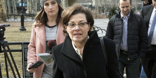 In this March 13, 2019 file photo, Nancy Salzman, center, arrives at Brooklyn federal court, in New York. Salzman, the former president and co-founder of NXIVM, was sentenced Wednesday, Sept. 8, 2021, to 42 months in prison and fined $150,000, but won't be locked up until January. 